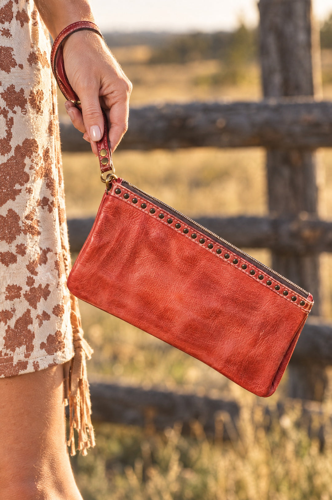 Red leather wristlet in hand