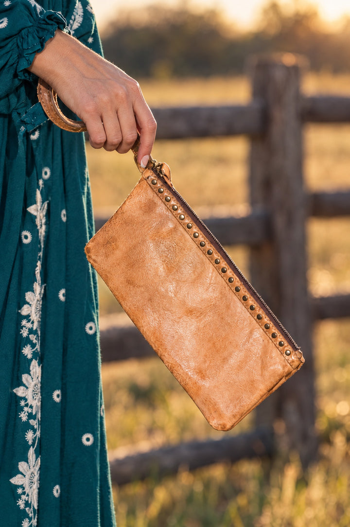 Tan leather wristlet in hand