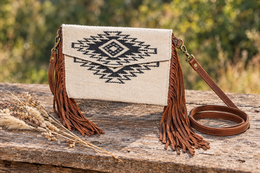 Aztec crossbody purse on a wood table outdoors