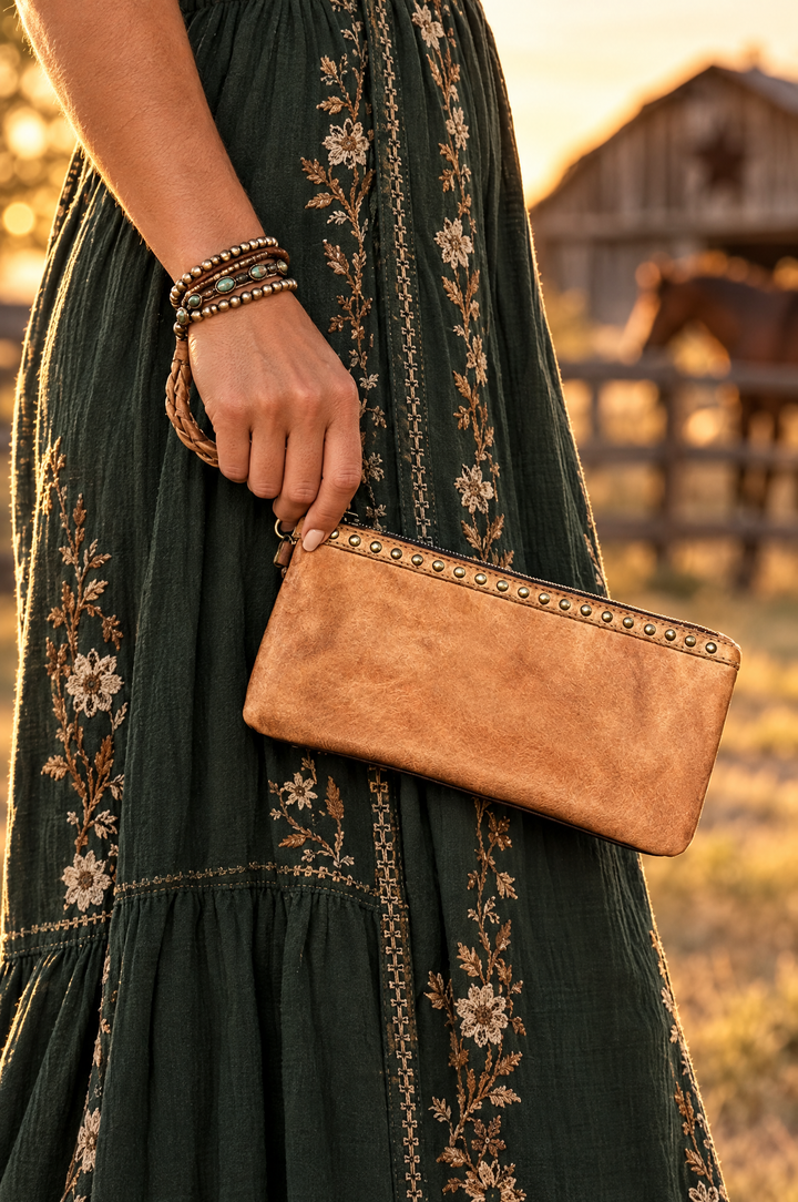 Tan leather wristlet pouch styled with maxi dress