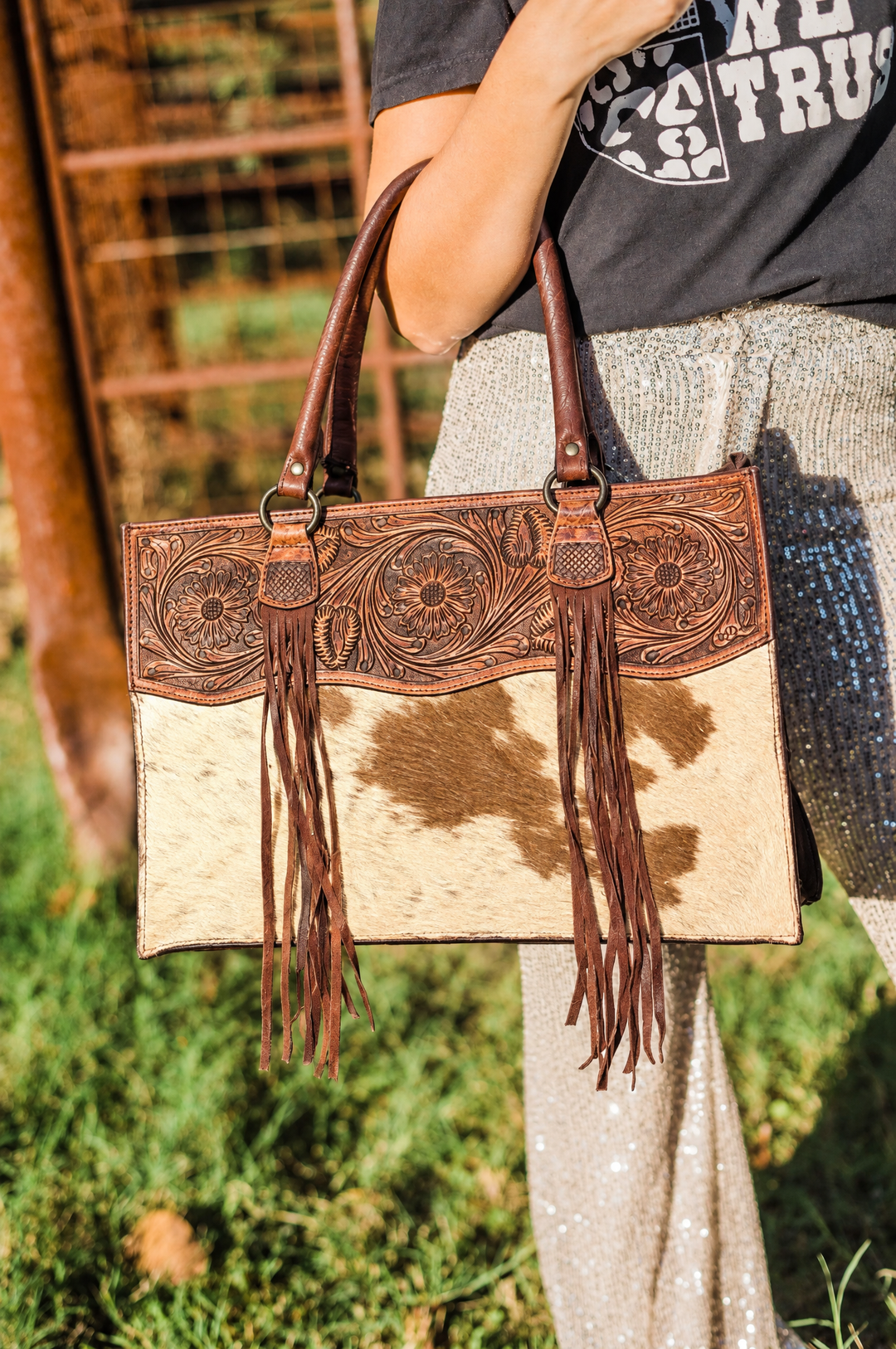 Tooled leather cowhide fringe tote on model