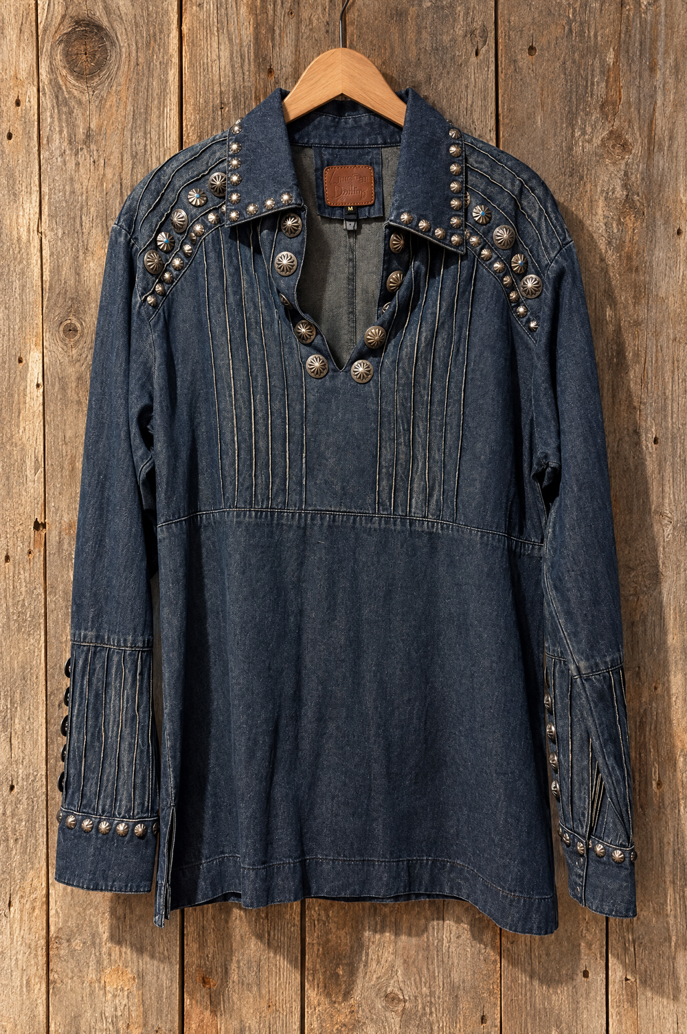 Studded denim tunic front on a hanger