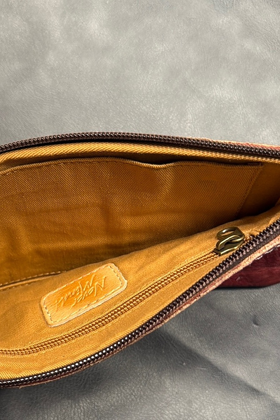 Inside of the Always Clutch wristlet in burgundy