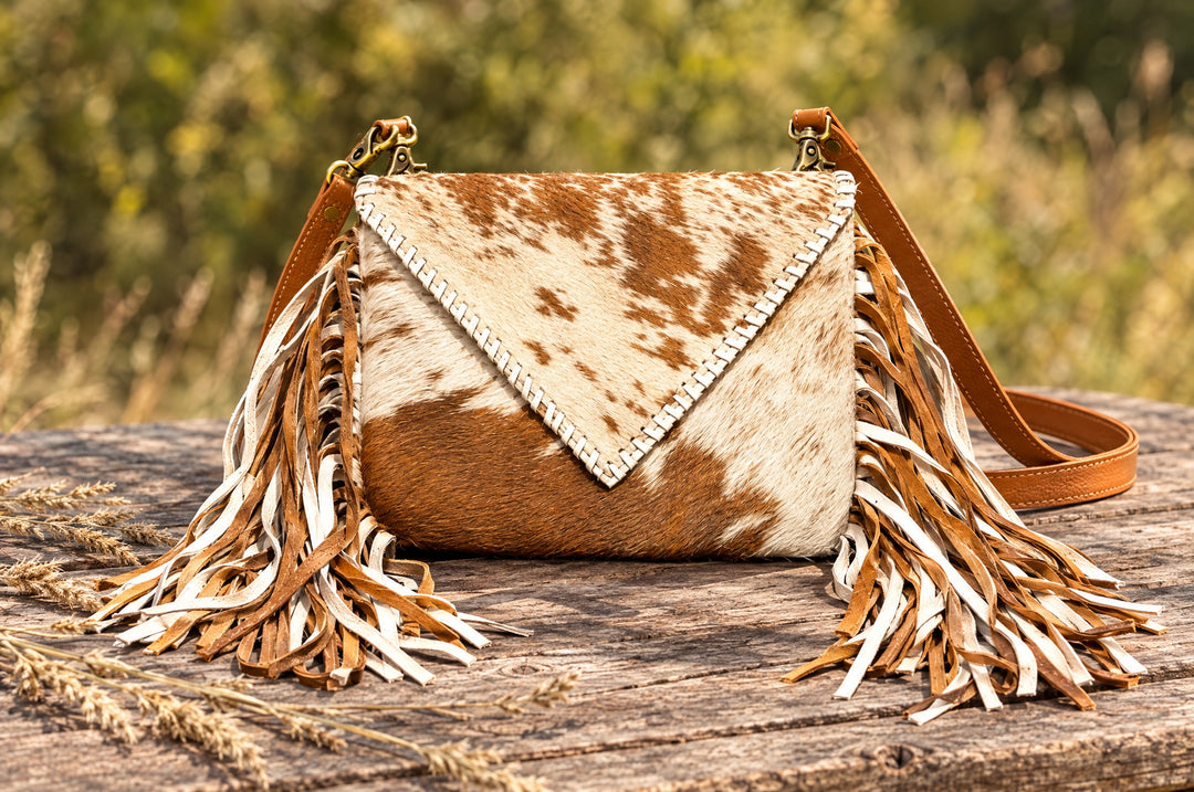 Moonlit Ranch crossbody on a wood table outdoors