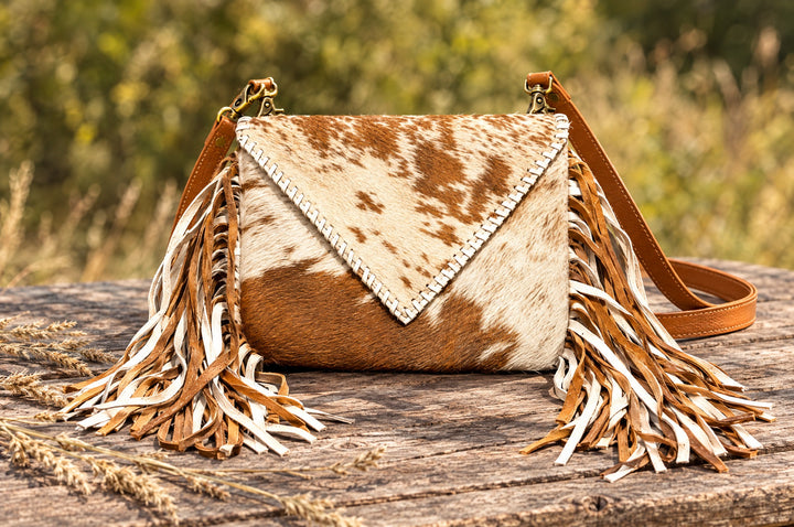 Moonlit Ranch crossbody on a wood table outdoors