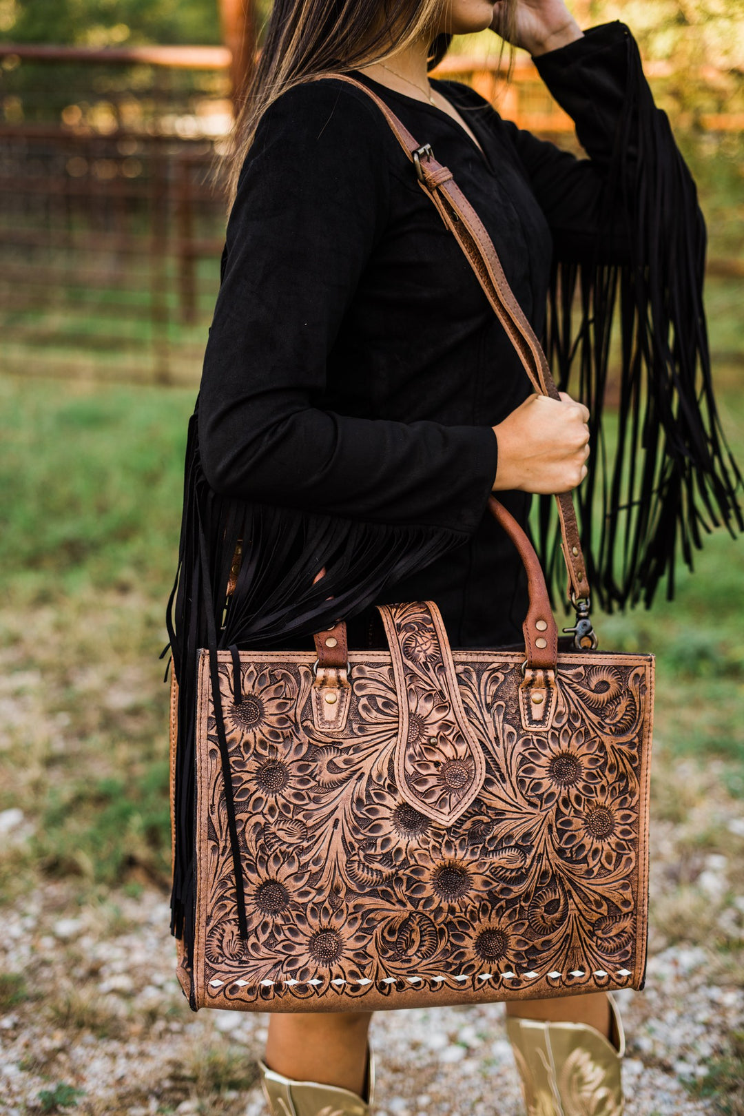 Sunflower tooled leather tote carried on the shoulder