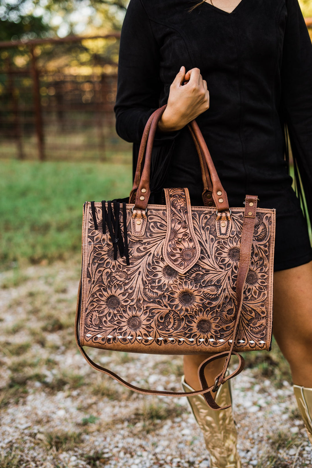 Sunflower tooled tote carried by the handles